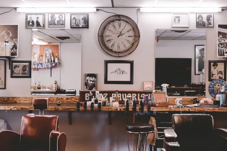 A barbershop interior with chairs, mirrors and tools
